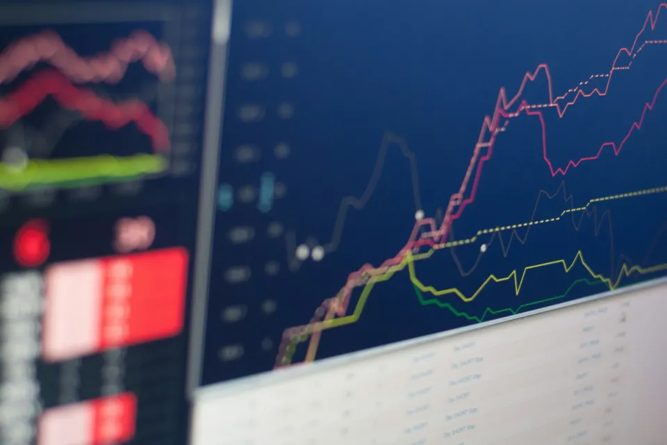 Financial analytics and market charts displayed on screens